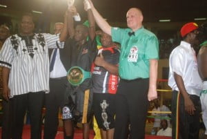 Le juge belge, Daniel Van de Wiele et le ministre David Kabré levant les mains de Yoyo en guise de victoire 